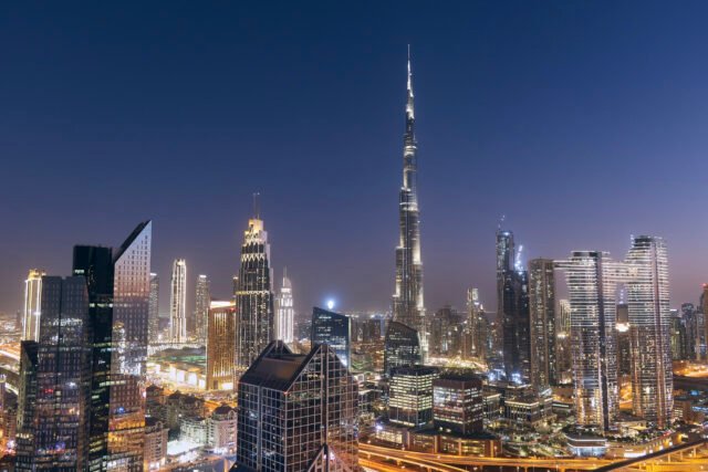 Nighttime cityscape of Dubai featuring the Burj Khalifa and modern skyscrapers, perfect for illustrating the experience of Moving to Dubai.